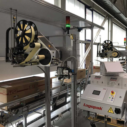 Carton labelling system from Logopak on a conveyor belt